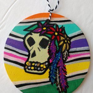 Handmade Striped Ornament With Painted Skull Wearing Flowers For Dia De Muertos
